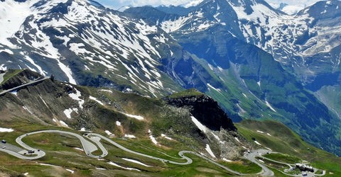 Mountain pass with hairpins and snow-capped peaks